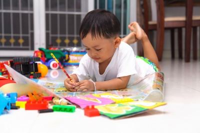 Happy Little Boy Drawing And Reading